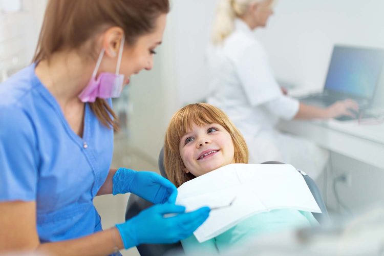 Young girl have a checkup at the dentista